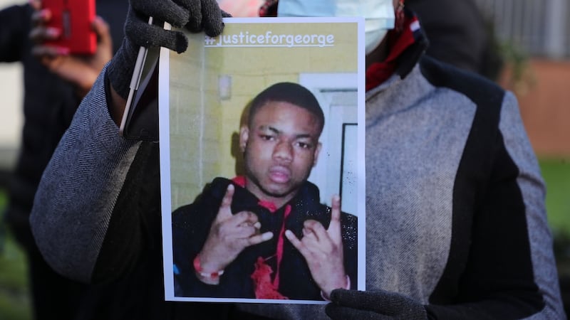 A protester holds up a photo of 27-year-old George Nkencho outside Blanchardstown Garda station. Photograph: Nick Bradshaw