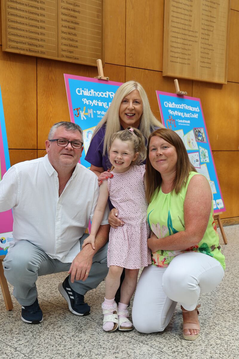 From left, Paul Arnold, home visitor Deirdre Bates, with  four-year-old Kate Arnold and Tracey McGaughren in the National College of Ireland in Dublin 1 for the graduation ceremony. Photograph: Nick Bradshaw