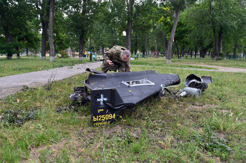 A Ukrainian explosives expert examines parts of a Shahed military drone that fell following an air attack last month. Photograph: Sergey Bobok/AFP