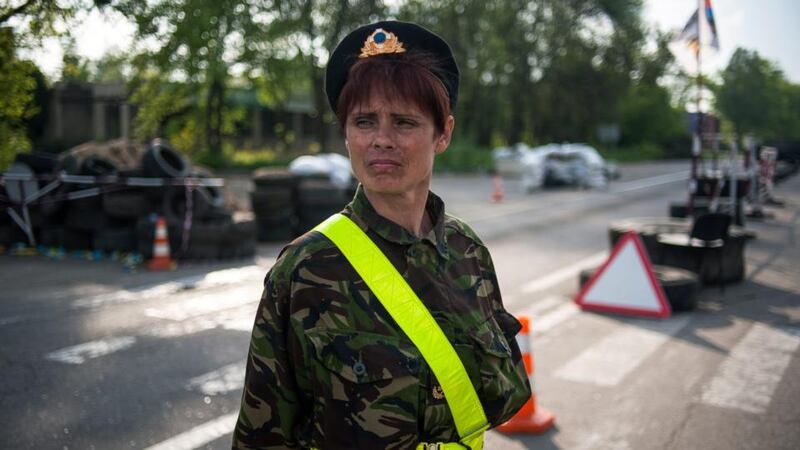 A pro-Russian protester guards a checkpoint in Slaviansk, Ukraine. Militants in Slaviansk are keeping dozens of hostages, including seven European military observers, who were detained in the city on 25 April while on a verification mission under the Organisation of Security and Cooperation in Europe. Photograph: Roman Pilipey/EPA