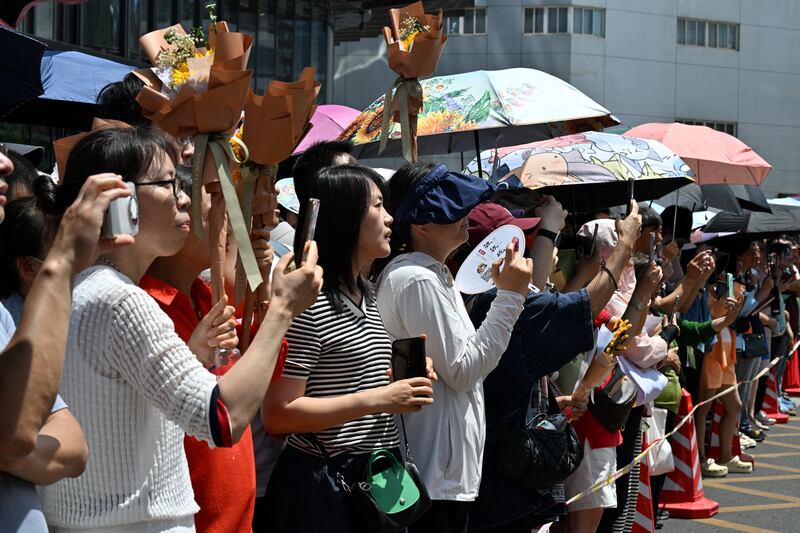 Parents wait for their children during the first day of China's "gaokao", outside a high school in Beijing. Photo: Adek Berry/AFP 