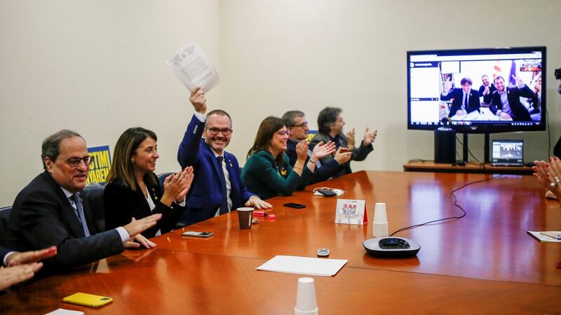 Catalan regional president Quim Torra (left), Catalan regional government spokeswoman Meritxell Budo (second left), and regional Catalan MP Josep Costa (third left) celebrate in Barcelona, along with other party colleagues, with former Catalan regional president Carles Puigdemont via conference, the European Court of Justice’s ruling. Photograph: Quique Garcia/EPA