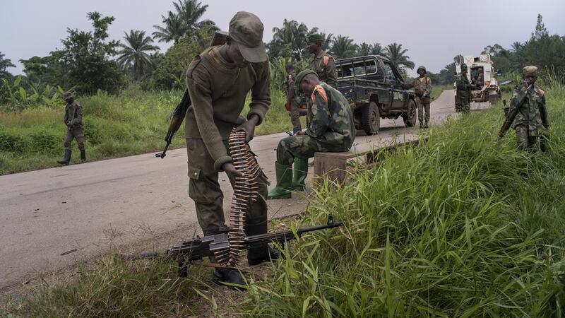 Government soldiers take a break after clashing with rebel militias in Mukoko, Democratic Republic of Congo.