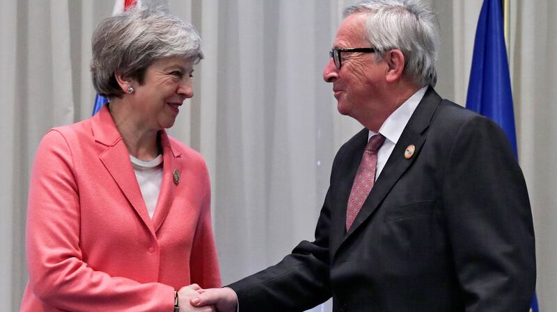 British prime minister Theresa May shakes hands with European Commission president Jean-Claude Juncker during a bilateral meeting on the sidelines of an EU-Arab League summit. Photograph: EPA