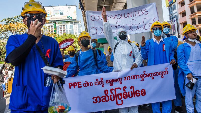 Healthcare workers wearing red ribbons, symbolising opposition to Myanmar’s military coup, in Yangon in February. Photograph: The New York Times
