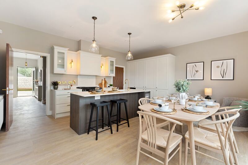 The kitchen comes fitted by BeSpace, with white units and an island with an oak finish