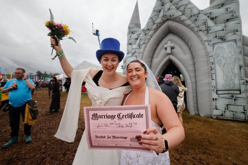 Michelle Hart and Jessica Dore from Clondalkin celebrate after ‘getting married’ in the inflatable church during the second day of Electric Picnic. Photograph: Alan Betson

