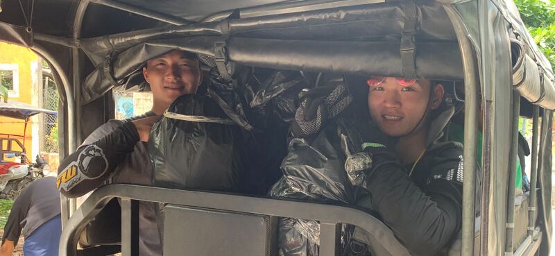 The two lads from Shanghai, sandwiched between bin liner bags in the back of a motocaro. Photograph: Peter Murtagh
