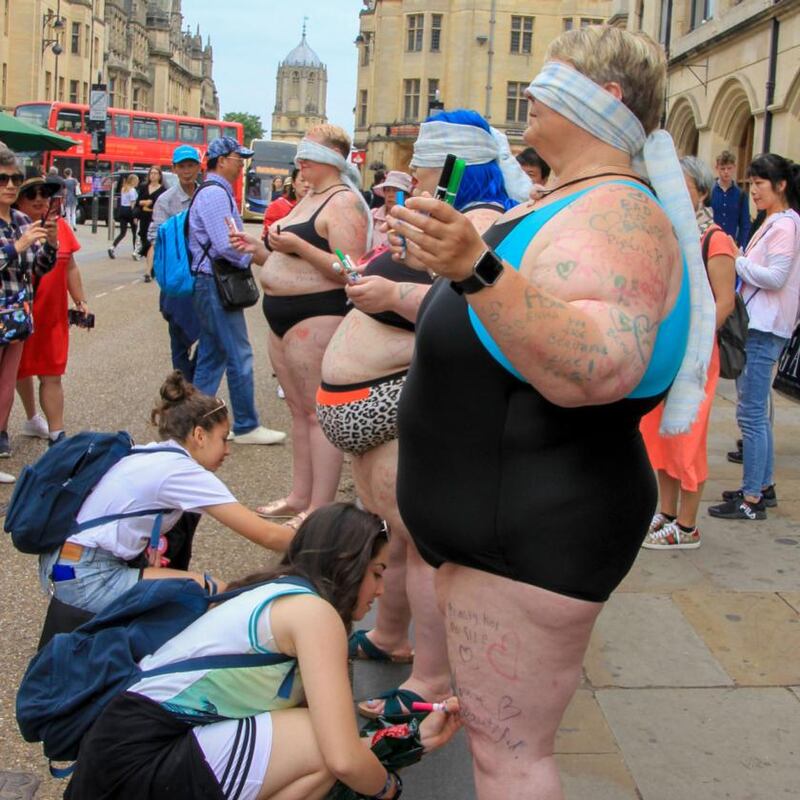 Victoria (left), Courtney (middle) and Babs (right) in the street taking part in Stand for Self-Love in Oxford. Photograph:  Sara Ramsden/Love Productions