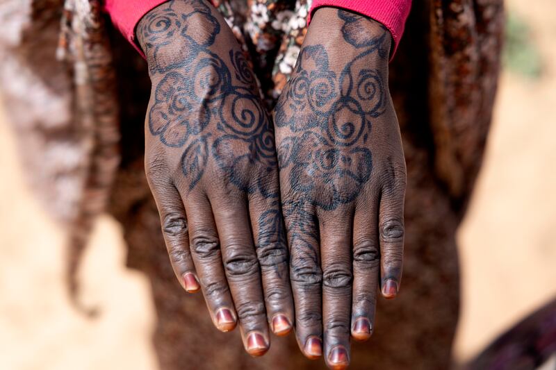 Maria Mahmoud Adam, who lives at the Farchana camp, has beautifully patterned hennaed hands, signifying that she is married. Photograph: Chris Maddaloni