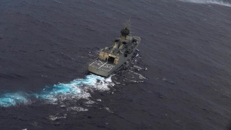 The Royal Australian Navy ship HMAS Perth is guided into position by a Royal New Zealand Airforce (RNZAF) P-3K2 Orion aircraft to recover an object in the southern Indian Ocean. Photograph: Greg Wood/Pool/Reuters