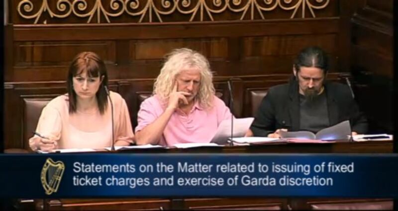 Screen grab of TDs, from left, Clare Daly, Mick Wallace and Luke ‘Ming’ Flanagan listening to Minister for Justice Alan  Shatter speaking in the Dáil this evening