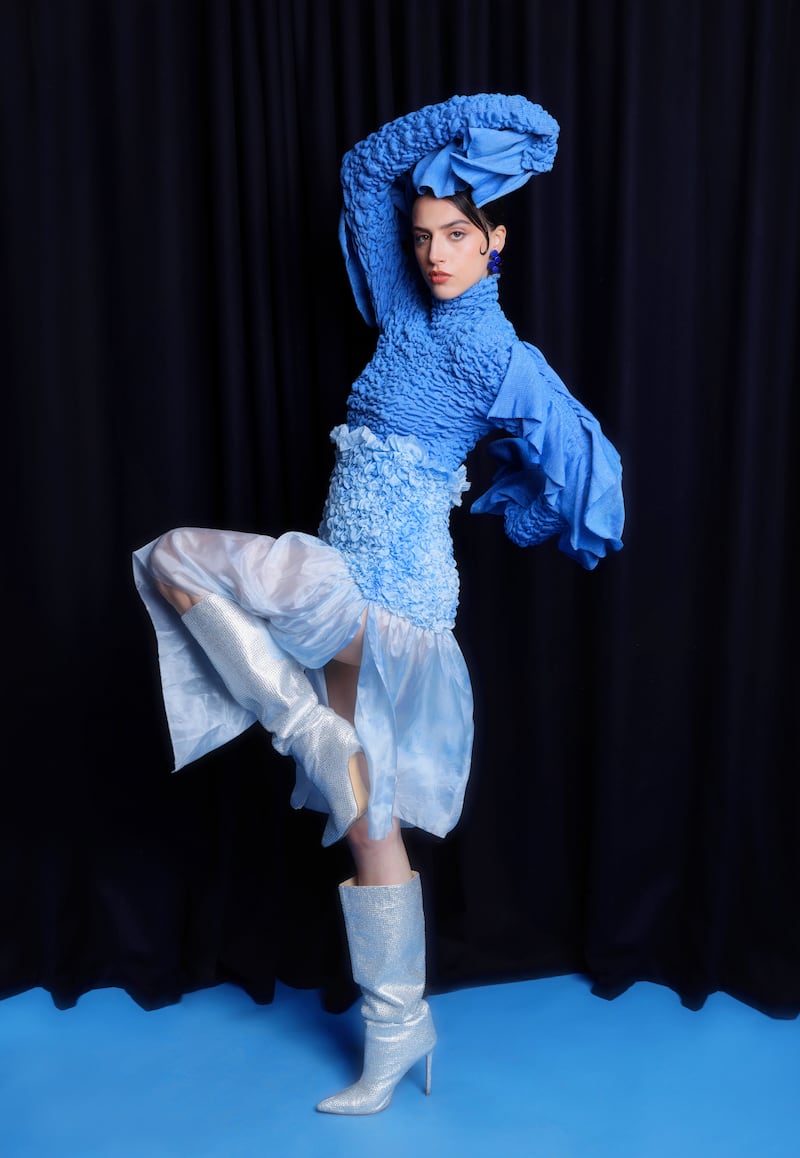 Blue silk and knit dress by Cosima Augustin, @cosima_augustin; blue metallic earrings by Iskin Sisters at The Collective; crystal boots, stylist's own