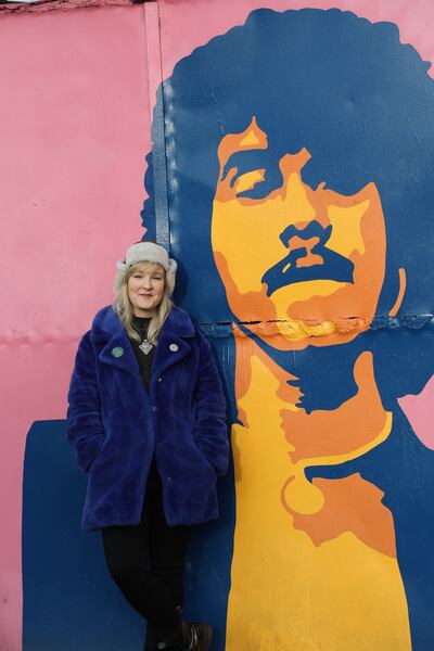Artist Sarah Bracken Soper with her Phil Lynnot mural in Crumlin, Dublin. Photograph Nick Bradshaw