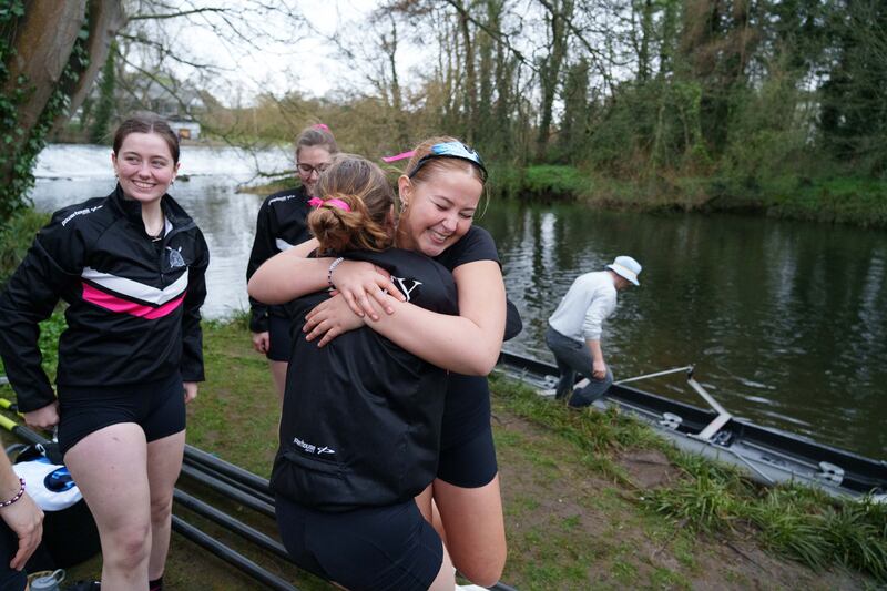 One of the novice Trinity teams celebrating their win as they get out of the water. Photograph: Barry Cronin