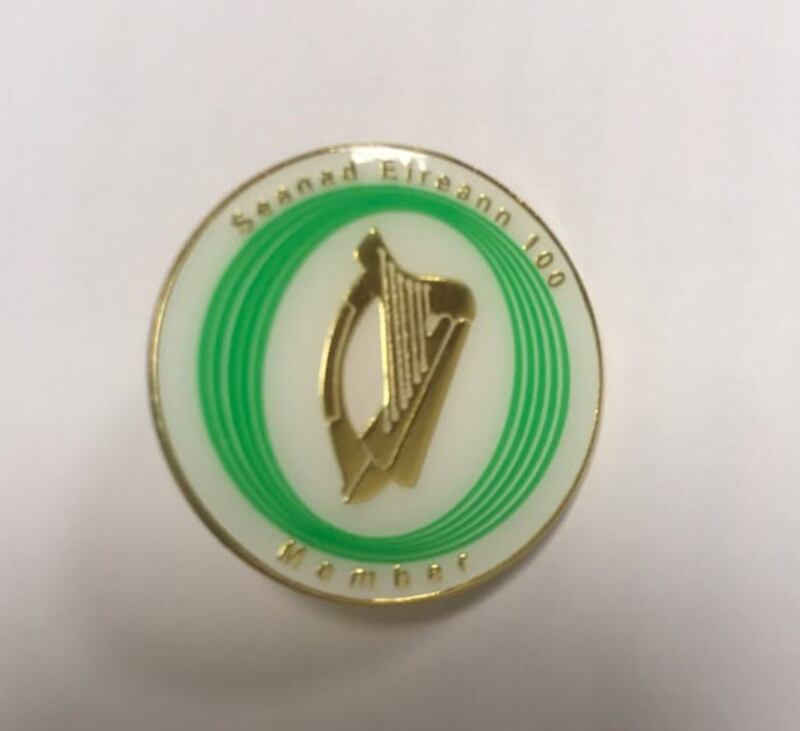 Fada, fada on Éireann: Seanad commemoration pin commissioned by Gerry Craughwell, with missing fada on ‘Éireann’