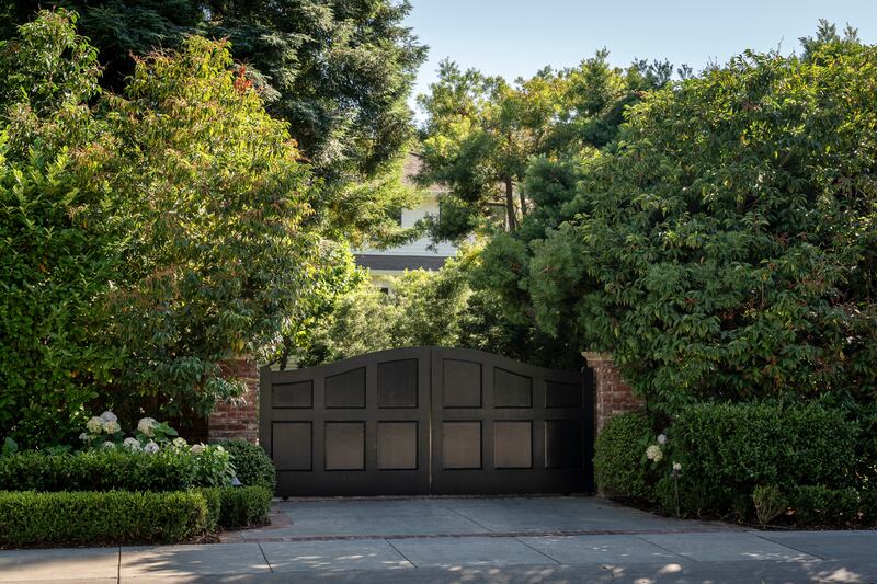 The gated entrance to a house owned by Mark Zuckerberg in Palo Alto. Photograph: Loren Elliott/The New York Times
                      