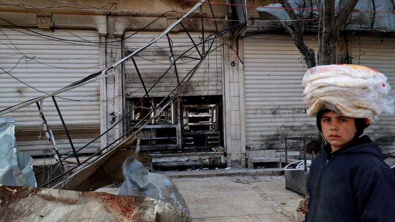 A boy walks past the site where a suicide attack targeting US-led coalition forces in the northern Syrian city of Manbij killed at least 15 people last week. Photograph: Delil Souleiman/AFP/Getty Images