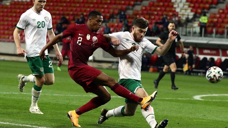 Ryan Manning vies for the ball with  Qatar’s Pedro Miguel Correia during the friendly in Hungary. Photograph:  Peter Kohalmi/AFP via Getty Images