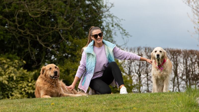 Rebecca Rose Quigley at home with her dogs, Gracie and Regan. Photograph: Rory Geary
