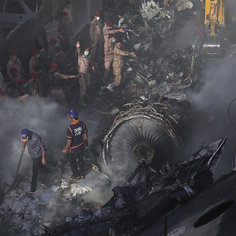 Rescue workers search for survivors amid the wreckage of the plane in Karachi. Photograph: Shahzaib Akber/EPA