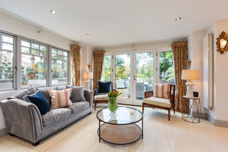 Living area with double doors out to deck and garden