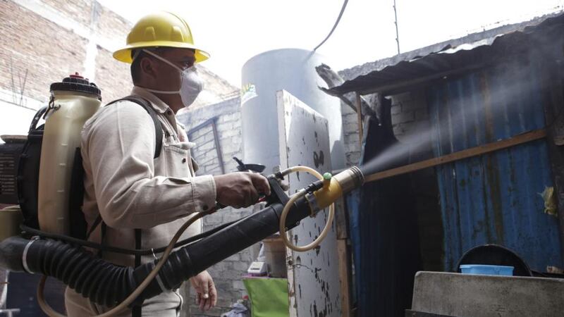A Mexican Health Ministry worker fumigates a house in Oaxaca, Mexico,  February 2nd, 2016. Secretary of health of Mexico Mercedes Juan confirmed 21 Zika cases have been registered in the country, with no pregnant women affected. Photograph: Mario Arturo Martínez/EPA