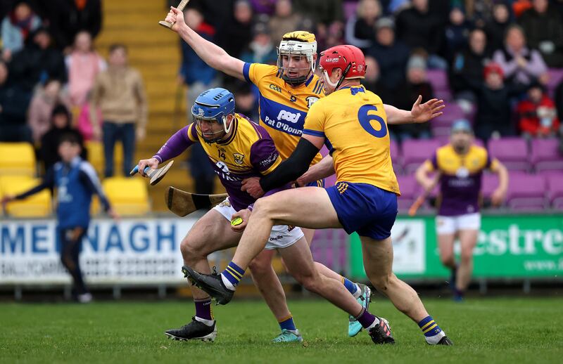 Wexford's Seamus Casey is tackled by John Conlon of Clare. Photograph: Bryan Keane/Inpho