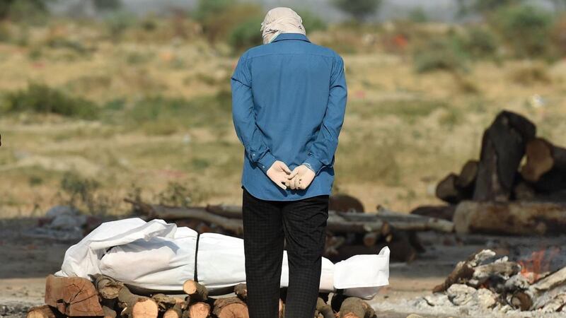A man mourns next to the body of his loved one at a cremation ground in Allahabad on May 4th. Photograph: Sanjay Kanojia/AFP via Getty Images