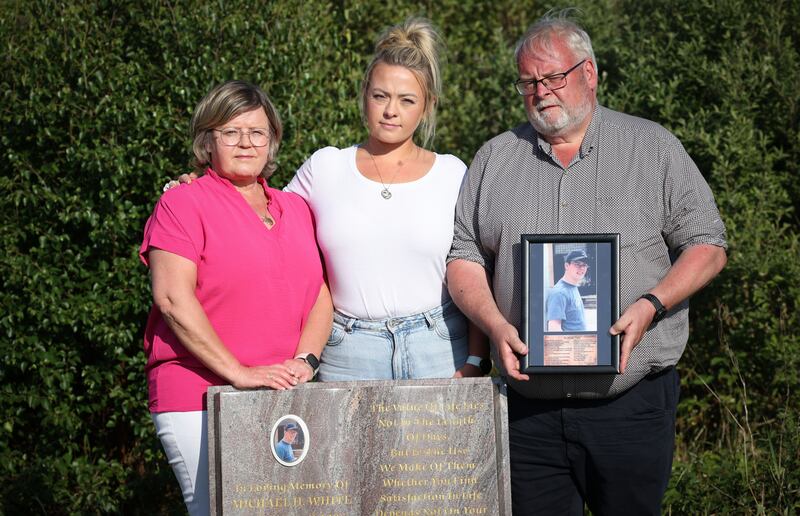 Martina, Ciara and Michael White at the roadside memorial in Clara, Co Offaly, where Michael White jnr was killed in a bus crash. Photograph: Laura Hutton