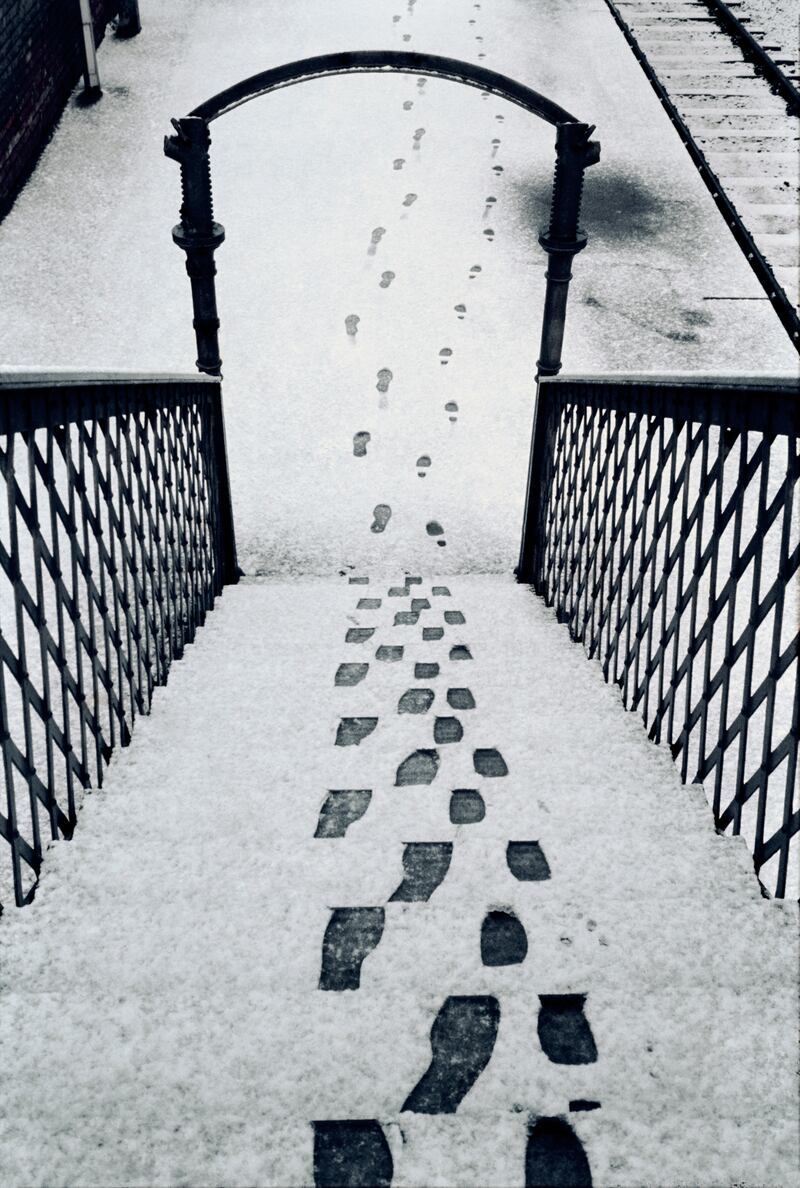 Footsteps in the snow on a railway overbridge in Antrim in the 1970s.