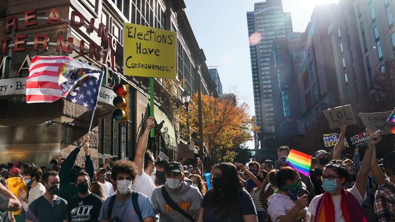 People celebrate outside the Pennsylvania Convention Center after Joe Biden was declared winner of the 2020 presidential election. Photograph: Bryan R Smith/AFP via Getty Images