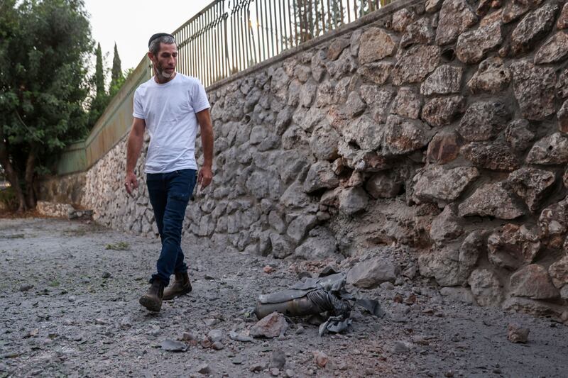 A man walks next to a fragment of a rocket reportedly fired from Lebanon in the northern Israeli town of Kiryat Shmona close to the border with Lebanon on October 18th. Photograph: Jalaa Marey/Getty Images