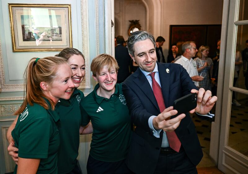 Taoiseach Simon Harris takes a selfie with Paralympians Cassie Cava, Catherine Sands and Chloe MacCombe during a reception at the Irish Embassy in Paris on Tuesday. Photograph: Harry Murphy/Sportsfile