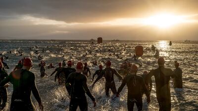 Competitors begin the swimming portion of the Wales Ironman in Tenby, Wales.