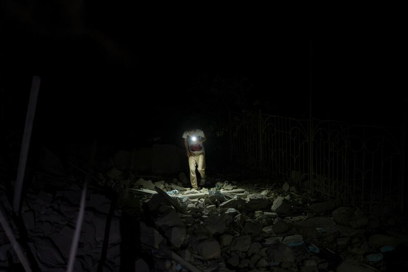 A resident walks through the rubble of an apartment building destroyed in Russian missile attacks in Odesa (Jae C. Hong/AP)