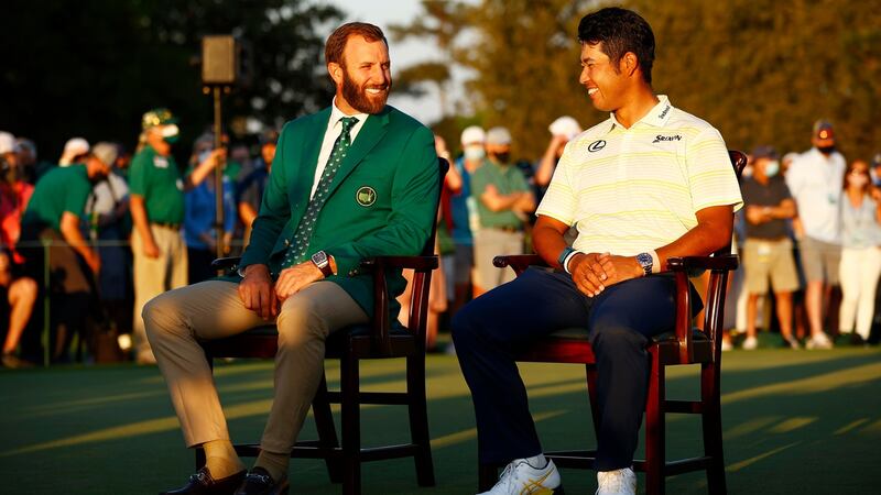 Matsuyama speaks to Dustin Johnson during the green jacket ceremony. Photo: Jared C. Tilton/Getty Images