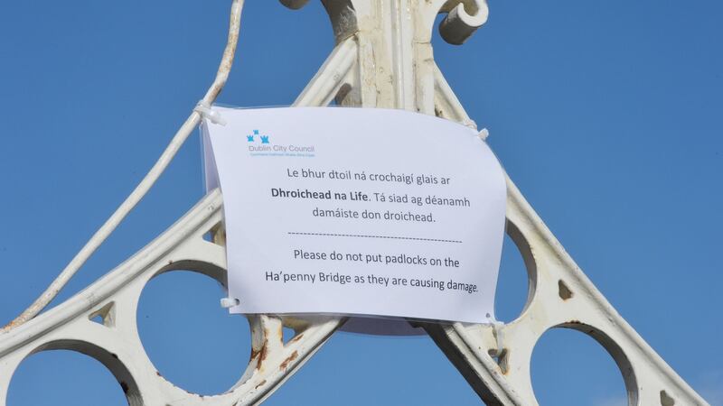 Dublin City Council sign requesting lovers not to attach locks to the Ha’Penny Bridge. Photograph: Alan Betson
