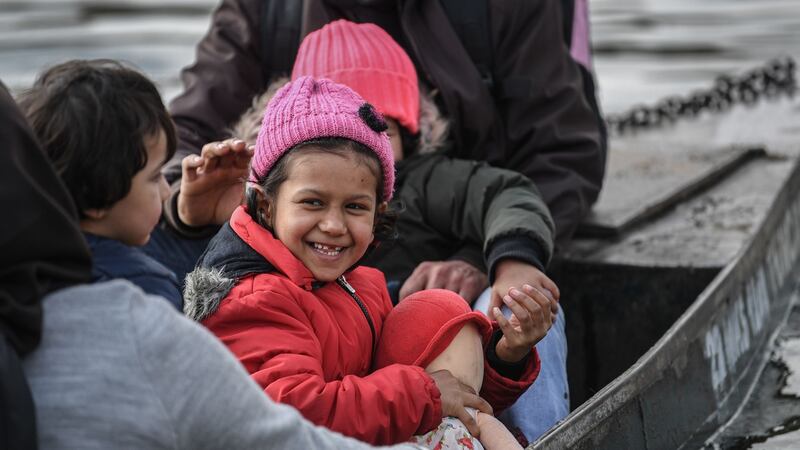 Migrants take a boat near Edirne while other migrants wait at Greece side, as they attempt to enter Greece by crossing the Maritsa river, on Sunday. Photograph: Ozan Kose/AFP via Getty Images