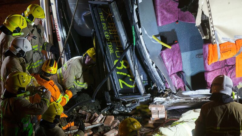 First responders work at the scene of a bus crash on Tai Po Road, near Tsung Tsai Yuen, Tai Po, Kowloon, Hong Kong, China. Photograph: Alex Hofford/EPA