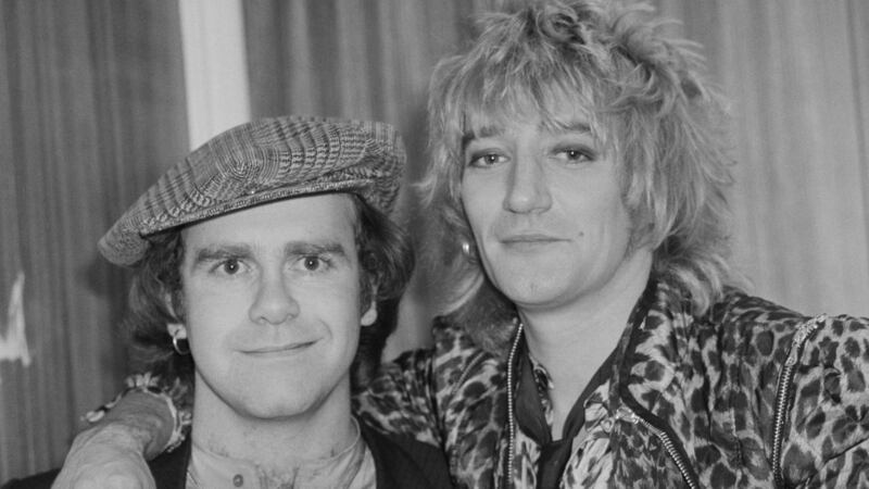 British singer, pianist and composer Elton John with British rock singer and songwriter Rod Stewart at the Olympia, London, on December 22nd,  1978. Photograph:  Evening Standard/Hulton Archive/Getty Images