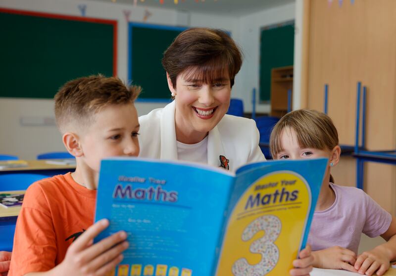 Minister for Education Norma Foley with pupils Dylan Hamilton (9) and Alana Hamilton (6) at St Mathew's National School in Dublin 4 where she formally launched the free primary schoolbooks scheme. Photograph: Alan Betson 
