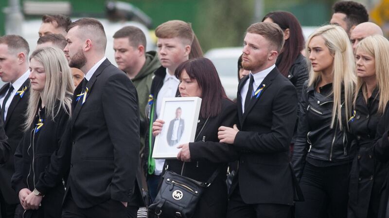 Stephen Lynch’s mother Vera, holding a framed photograph, during her son’s funeral at St Aidan’s Church, Brookfield, Tallaght. Photograph: Collins