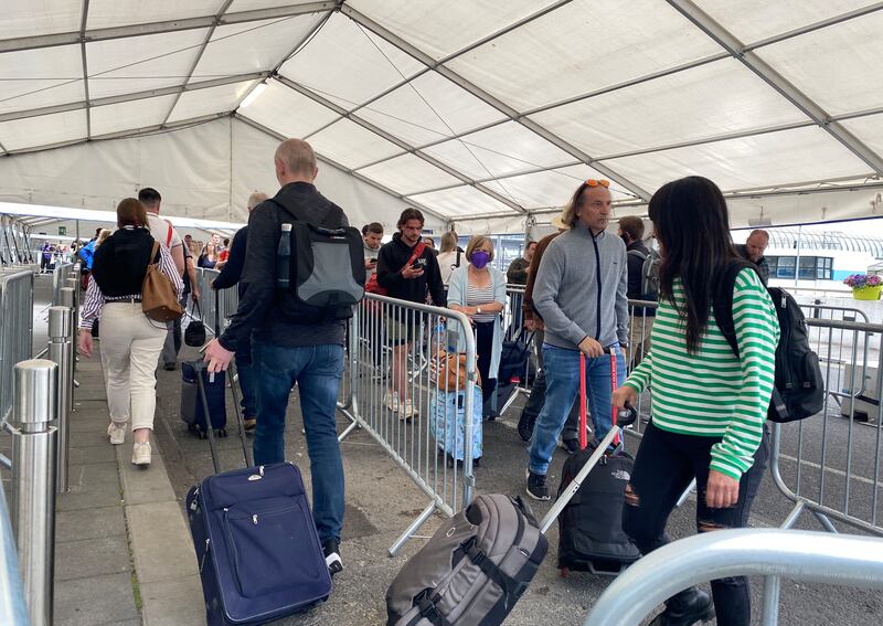The Queue for passengers  to enter Terminal 1 at Dublin Airport started in the Short term car park before heading upstairs leading over the access bridge and through the tented queueing area (in Photo) before entry to the Terminal Building. Photograph: Alan Betson / The Irish Times


