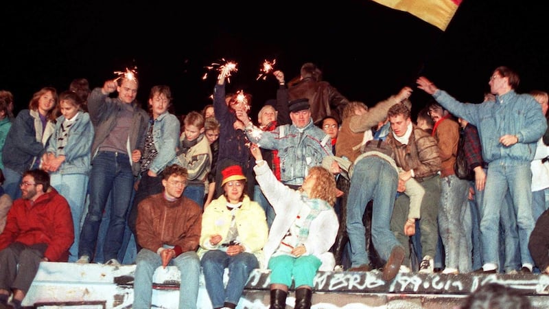 This photo taken on November 11, 1989 in Berlin shows young East Berliners celebrating atop the Berlin Wall. Photograph by: AFP/Getty