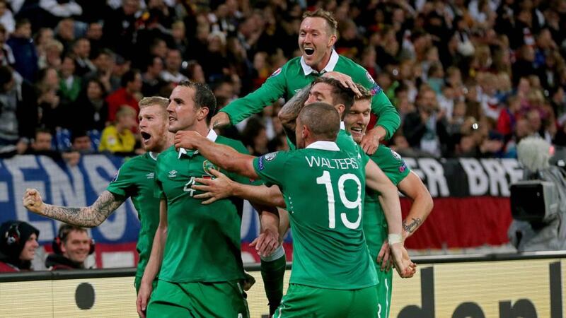 Republic of Ireland’s John O’Shea (second left) celebrates with teammates after scoring the equaliser in injury timein Gelsenkirchen.  Photograph: Donall Farmer / Inpho