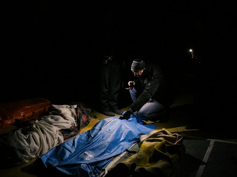 People search for the bodies of missing relatives in a gymnasium now serving as a morgue following the earthquake, in Kahramanmaras, Turkey. Photograph: Emin Ozmen/New York Times