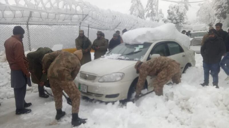 Army soldiers take part in a rescue operation to clear a road covered with snow in Murree, around 70km  northeast of the capital, Islamabad. Photograph: Inter Services Public Relations/AFP via Getty Images