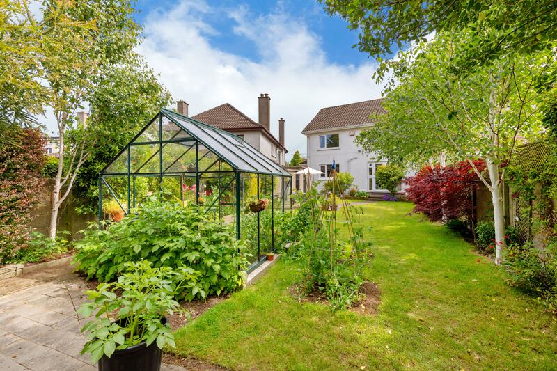 The garden has a greenhouse and old apple trees 