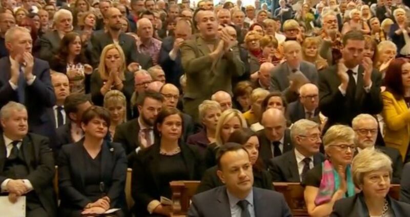 The congregation begins to stand and applaud Fr Magill homily